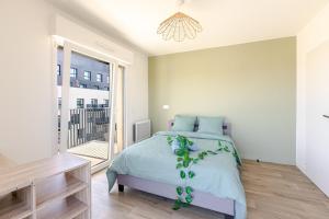 En eller flere senge i et værelse på 2P moderne avec balcon et vue à Massy Palaiseau