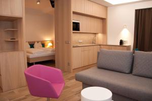 a living room with a couch and a bedroom at Seeappartements Bürger in Krumpendorf am Wörthersee