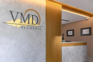 a lobby with a sign on the wall at VMD Residence in Braşov