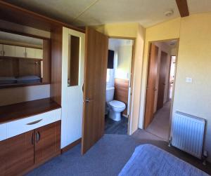 a room with a bathroom with a toilet in it at Woodside, Meadows Retreat, Cockermouth in Plumbland