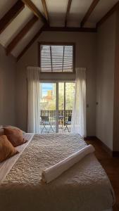 a bedroom with a large bed and a large window at Tribu in Viña del Mar
