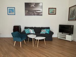 a living room with a couch and a table and a tv at Casa In Piazza in Minori
