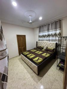 a bedroom with a large bed in a room at Adwoa Gyemfua's Haven in Trofwi