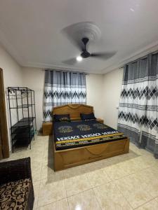 a bedroom with a large wooden bed in a room at Adwoa Gyemfua's Haven in Trofwi