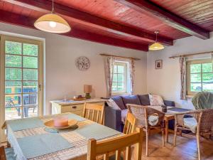 a living room with a table and a couch at Chaloupka u Bílého potoka in Kuklík