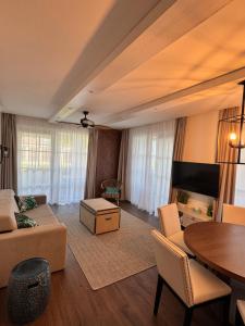 a living room with a couch and a table at BalaLove Full Panoramic view in Szántód