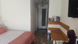 a bedroom with a bed and a small hallway at Pornic Studio in Pornic