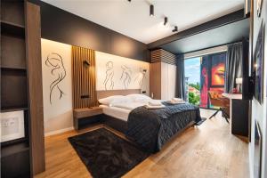 a bedroom with a bed and a large window at Central Paul Deluxe Apartment - by Open House in Timişoara