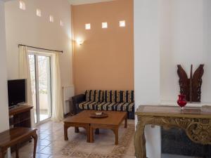 a living room with a couch and a table at St Nickolas Guest House in Artemida
