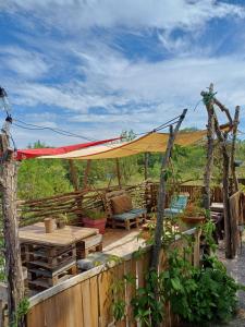 a patio with a tent and a table and chairs at TENTES sur une aire privée en pleine nature in Massillargues-Attuech