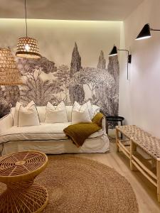 a living room with a white couch and a mural at Les Suites de Collioure in Collioure