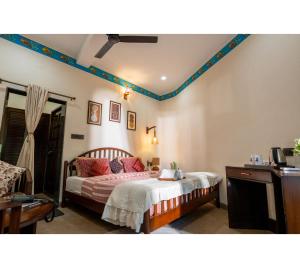 a bedroom with a bed with red pillows on it at Jungle Ghar,Pachmarhi in Pachmarhī
