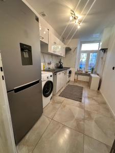 a kitchen with a refrigerator and a dishwasher at Hostel w samym Centrum Radomia ! in Radom