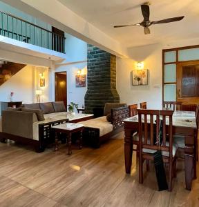 a living room with a couch and a table at Villa Aavaas 2 in Kukri Ser
