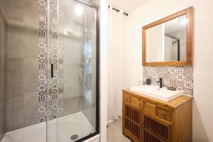 a bathroom with a shower and a sink and a mirror at La Terrasse du Bonheur in Le Mans