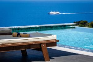 a mattress sitting on a table next to a swimming pool at Villa Mavraki in Glossa