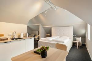 a kitchen and a bedroom with a bed in a room at Breitorget Apartments in Stavanger