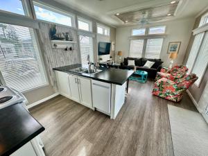 a kitchen with a sink and a living room at Flip Flop Inn amazing 1 bedroom 1 bath beach bungalow in Jensen Beach