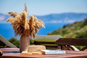 a vase filled with dry grass sitting on a table at Villa Mavraki in Glossa