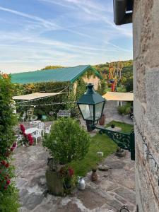 a street light on a building with a garden at O Forno de Catuxa Cottage & Roman Wall in Lugo