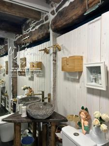 a bathroom with a sink and a counter at O Forno de Catuxa Cottage & Roman Wall in Lugo +45 photos