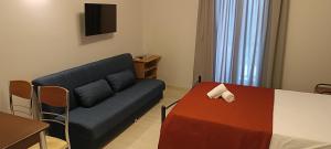 a living room with a couch and a table at Andros Guesthouses in Andros
