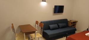 a living room with a couch and a table at Andros Guesthouses in Andros