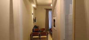 a room with chairs and a table and a window at Andros Guesthouses in Andros