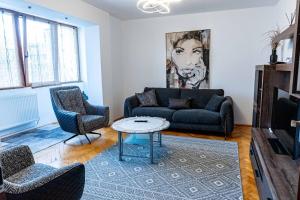 a living room with a couch and a table at RUM Apartment in Cluj-Napoca