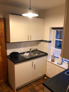 a kitchen with a sink and a counter top at Die 5 Ferienwohnungen der Familie Weber in Fehmarn +97 photos