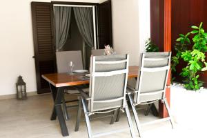 a dining room table with two chairs and a wooden table at Lavica Beach apartment in Podstrana
