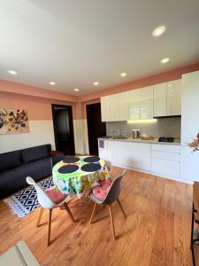 a kitchen and a living room with a table and chairs at Devdaraki Apartments N 113 in Kazbegi