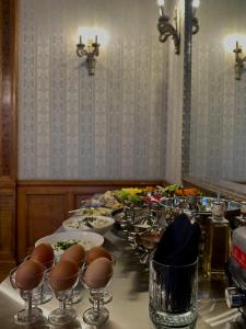 a long table with plates of food and wine glasses at The Benjamin House in Rīga +37 photos
