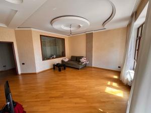 a living room with a couch in the middle of it at Firstdeal in Mekhrably +2 photos