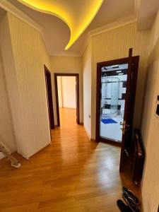 an empty room with a hallway with a yellow ceiling at Firstdeal in Mekhrably