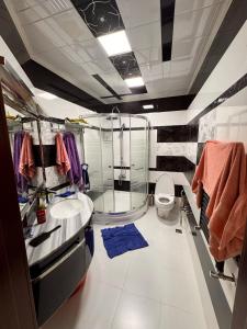 a bathroom with a shower and a sink and a toilet at Firstdeal in Mekhrably
