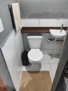 a bathroom with a white toilet and a sink at Loftjesus in Campina Grande +11 photos