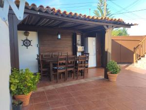 a patio with a table and chairs under a pergola at Casa Alicia in Poio