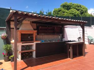 a outdoor kitchen with an outdoor oven in a backyard at Casa Alicia in Poio