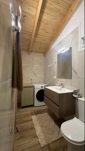 a bathroom with a sink and a washing machine at Garden House Flogita in Flogita +20 photos