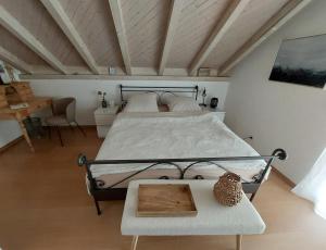 a bedroom with a large bed and a table at Au doux repos in Bure +5 photos