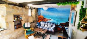 a living room with a view of the ocean at Coeur de granit rose, meublé alliant le charme de l'authentique breton et du confort, classé 3 étoiles, à 5mn de 13 plages de la réputée cote de granit rose in Trégastel