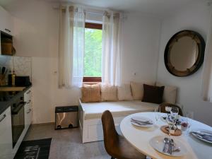 a living room with a table and a couch at Apartment Hosner in Lepena