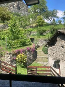 a view of a garden with benches and flowers at Casa Vanda in Châtillon