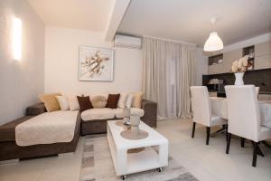 a living room with a couch and a table at Apartmani Mery in Rab