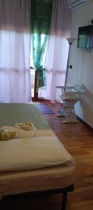 a bedroom with a bed and a window with curtains at Alla fiera di Roma in Ponte Galeria