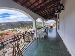 a balcony with tables and chairs and a view at Sinhá Moça Diamantina-MG in Diamantina