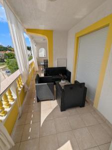 a living room with a couch and a table at Apartmani Mery in Rab