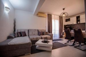 a living room with a couch and a table at Apartmani Mery in Rab