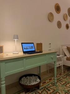 a desk with a laptop sitting on top of it at Civico 39 in Ostuni +40 photos